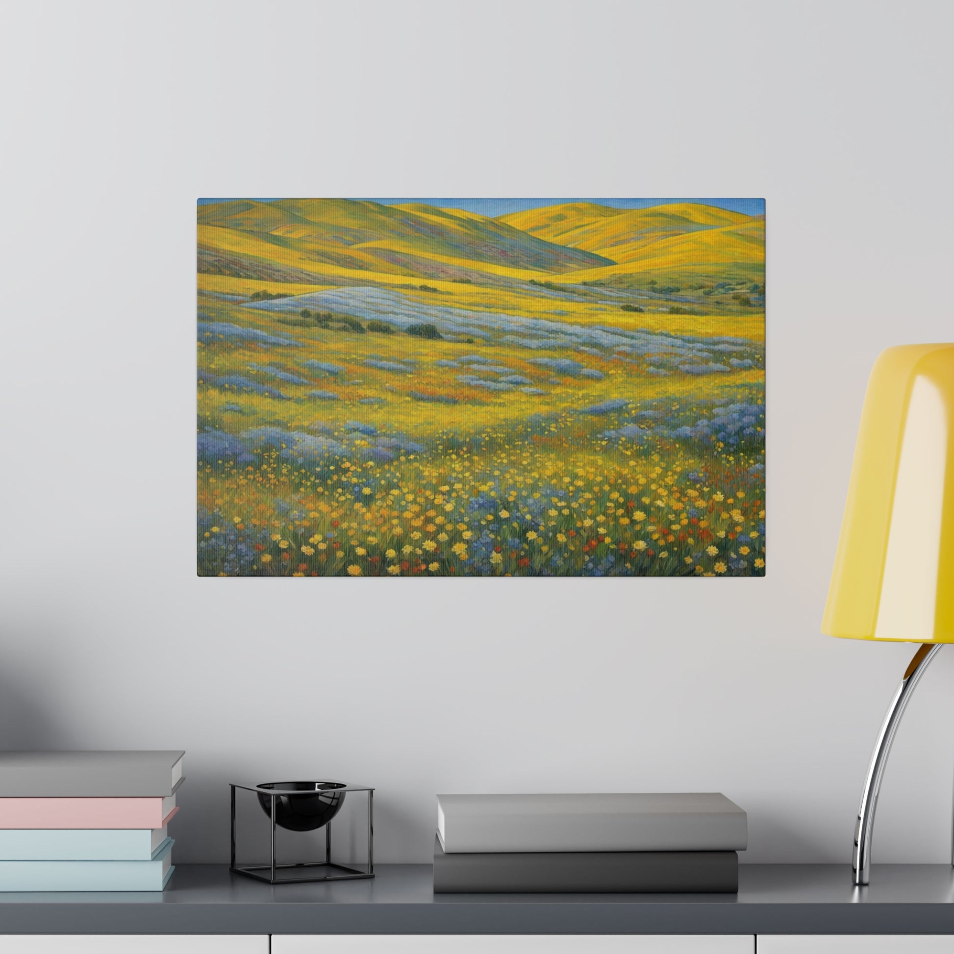 California Carrizo Plain Super Bloom. A vast landscape is covered with vibrant yellow wildflowers, stretching toward rolling hills on the horizon. Blue and purple flowers add a dash of contrasting color against the golden yellow bloom and green grasses swaying under a clear sky.