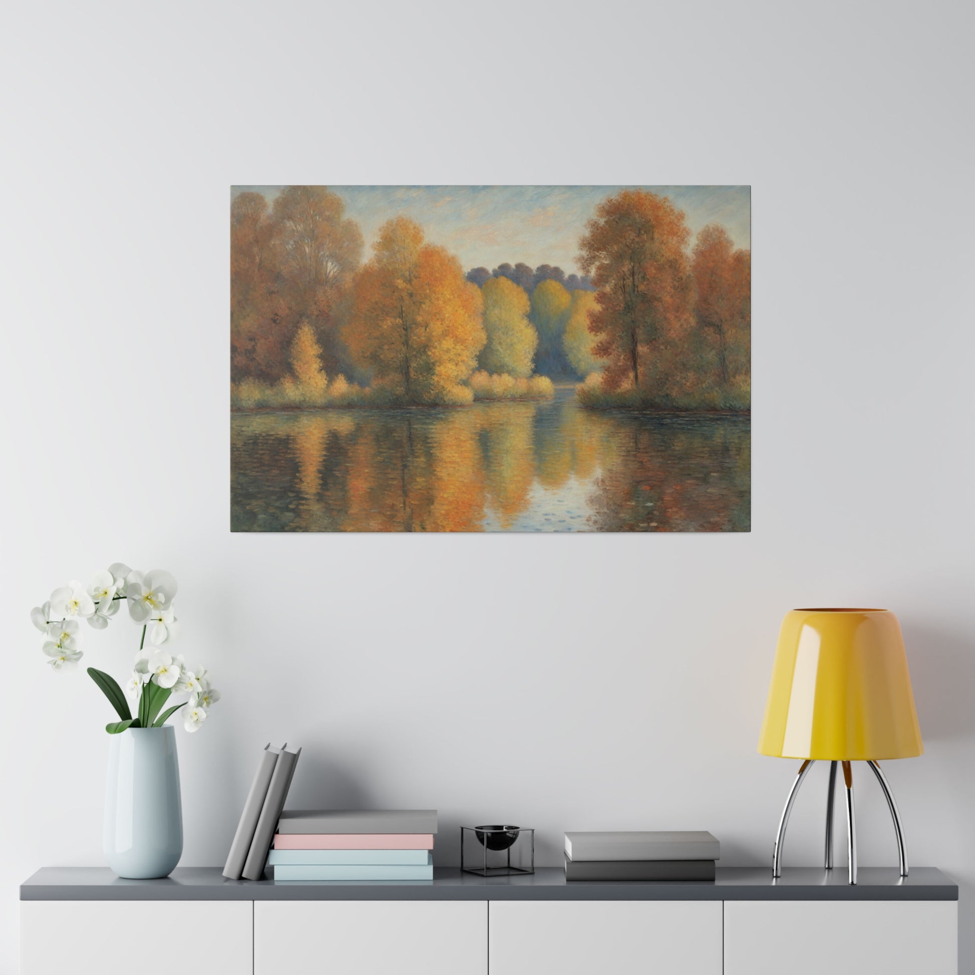 A serene lake reflects a vibrant display of autumn trees with hues of orange, yellow, and red. The soft, pastel sky above complements the tranquil scene, enhancing the overall sense of peace.