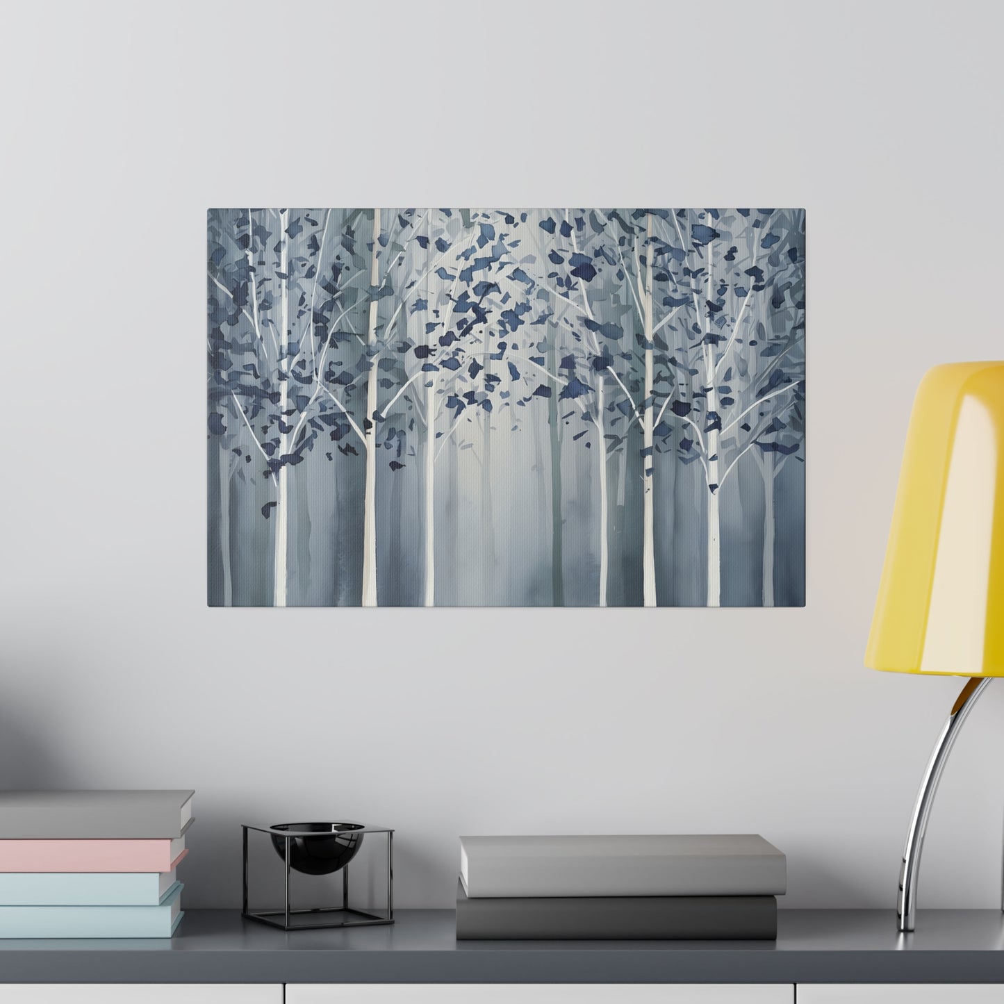 A serene grove of slender trees stands shrouded in mist, their leaves a cool tapestry of blues against the muted backdrop. The scene evokes a tranquil and somewhat mystical forest atmosphere, with the trees fading into the white foggy distance.