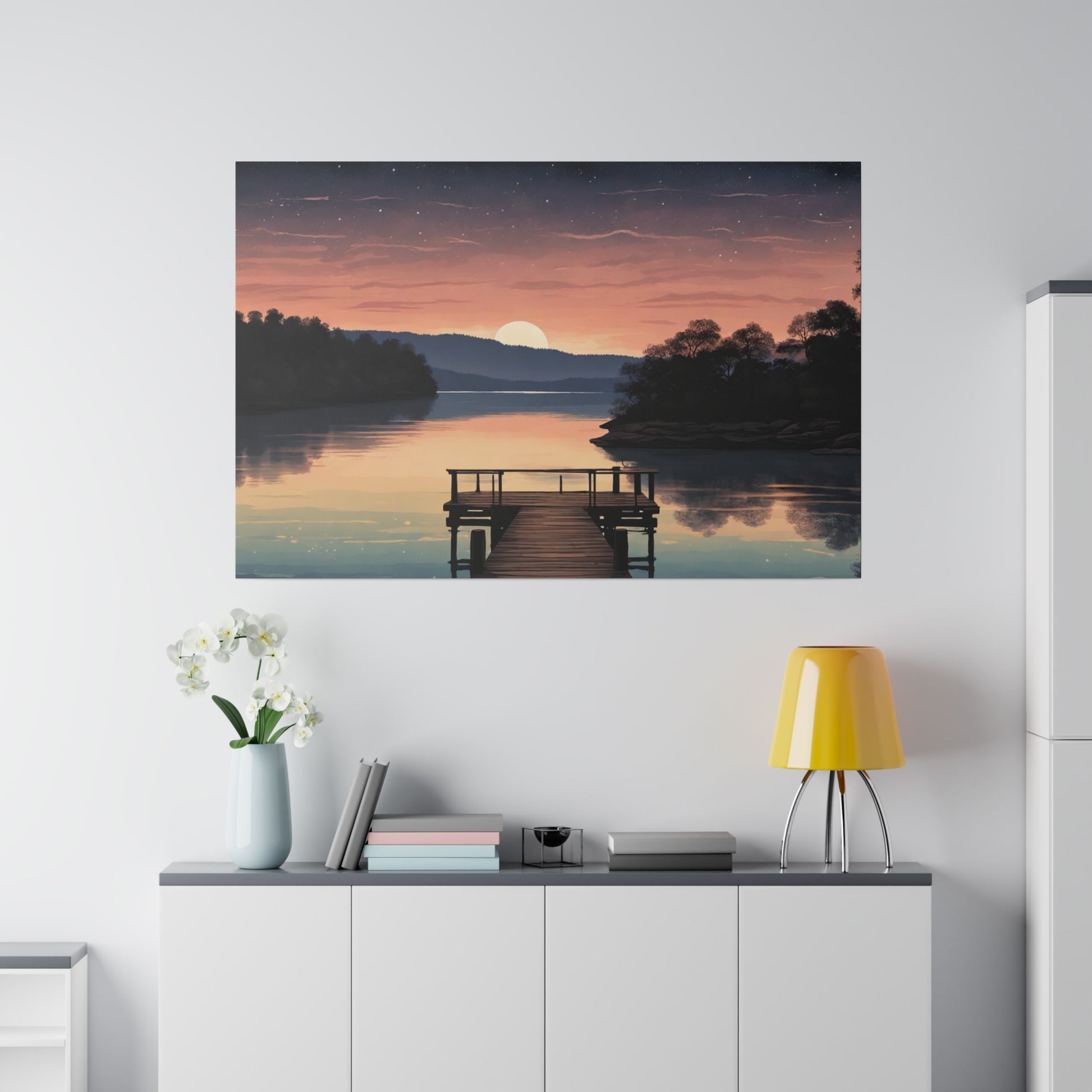 A serene sunset casts warm hues over a smooth lake, with a wooden dock leading into the still water. Stars begin to pepper the dusk sky as the final slice of the sun dips behind a distant tree-lined horizon. Tranquil Serenity Lake Canvas Print